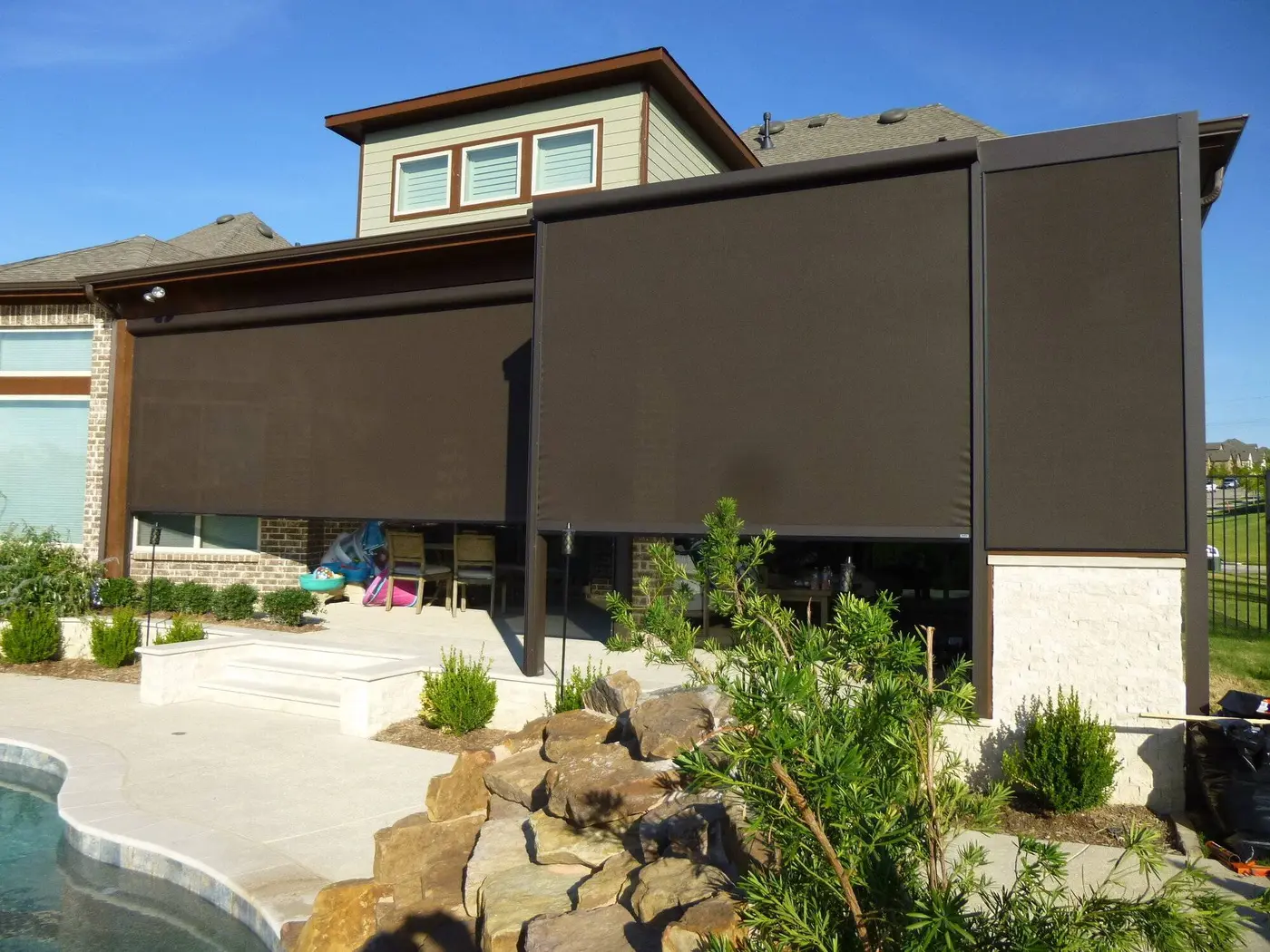 View of an EX Design Group motorized patio screen installation.